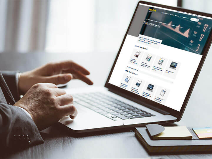 Close up of businessman using a laptop to look at Intertek's Medical Resources hub