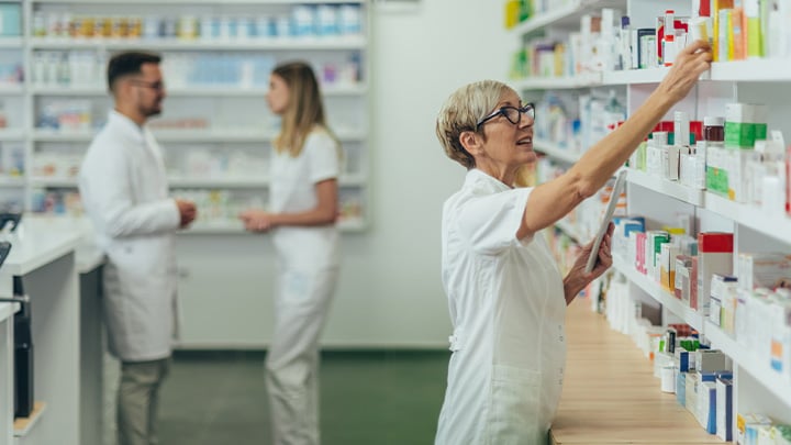 Pharmacist stocking a shelf