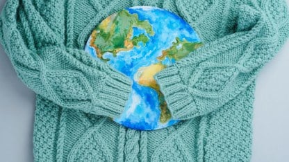 Sleeves of knitwear sweater hug the planet.