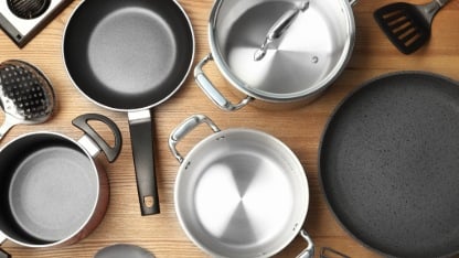 Flat lay composition with clean cookware on wooden background