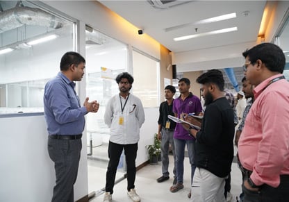 An Intertek colleague addresses a small group of university students. 