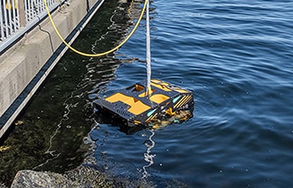 yellow underwater robotic vessel near a pier