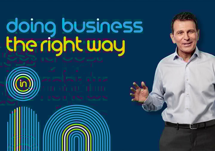 Intertek's CEO André Lacroix stands in front of a dark blue background next to the words 'doing business the right way'.