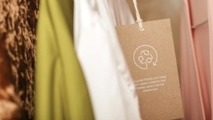 Close up of clothing tag with recycle icon