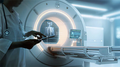 female doctor using digital tablet for advanced Mri x-ray scan medical diagnosis machine at hospital health care lab as wide banner with copy space area