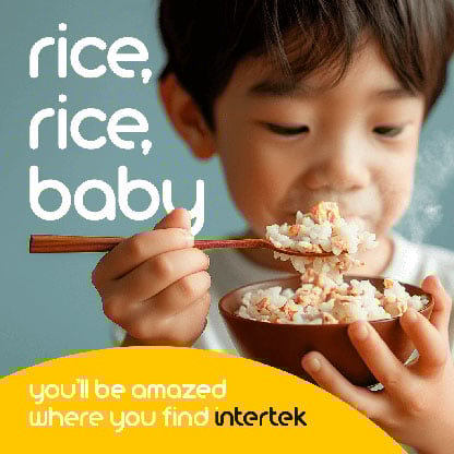 Young boy eating rice out of a bowl using chopsticks